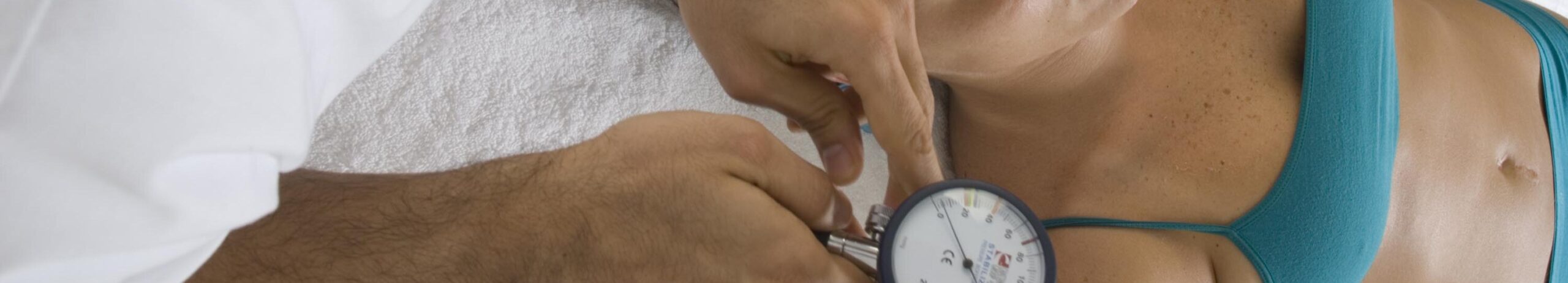 Physiotherapist performing cervical assessment with an inclinometer